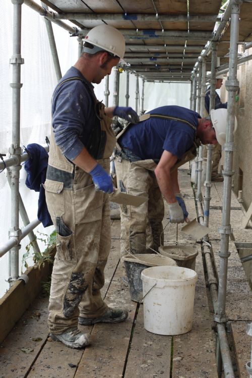 Benny, Andrew and George apply the second coat of lime harl